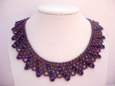 a purple beaded necklace is displayed on a mannequin's neckline