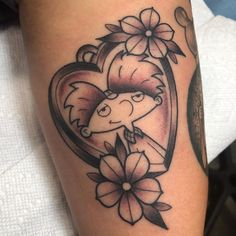 a woman's arm with a heart and flowers on it