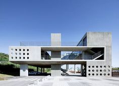 a large concrete building with stairs leading up to it