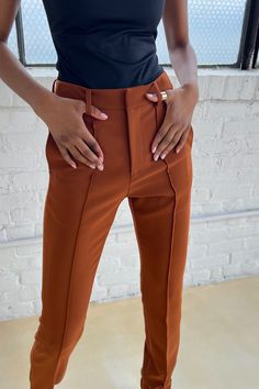 Introducing the Didi Pant — a manifestation of sultry allure, timeless elegance, and unmistakable power. Meticulously crafted for the connoisseur of luxury, these trousers redefine sophistication, seamlessly blending versatility with a commanding presence. The Didi Trouser boasts a straight fit, expertly tailored to accentuate your silhouette with a touch of modern flair. Front and back pintucks add a subtle yet striking detail, elevating these trousers beyond the ordinary. With side seam pocket Luxury Timeless Straight Pants, Luxury Modern Straight Pants, Luxury Designer Straight Pants, Luxury Designer Tailored Pants, Luxury Trousers With Zipper Closure, 4-way Stretch Solid Color Trousers, Luxury Orange Trousers, Brown Copper, Fall Essentials