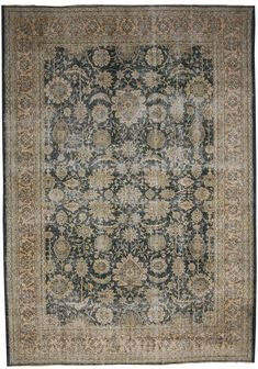 an antique rug with blue, beige and green colors on it's border is shown