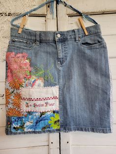 Women's size 8 denim skirt.  Uniquely upcycled using vintage fabrics, linens and trims.  All embellishments, including stitching and embroidery are sewn by hand.  In honor of St. Therese of Lisieux, also call The Little Flower.  St. Therese was a French Catholic Discalced Carmelite nun who is widely venerated today around the world.  She is the patron of missions and of florists. Upcycled Blue Denim Skirt For Spring, Embroidered Medium Wash Denim Skirt, Bohemian Denim Skirt With Patchwork Details, Bohemian Denim Skirt With Patchwork, Spring Cotton Skirt Upcycled, Upcycle Jeans Skirt, Upcycle Skirt, Artisanats Denim, Jeans Refashion