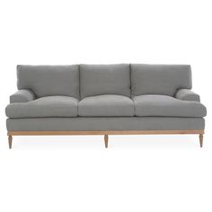 a gray couch sitting on top of a wooden frame