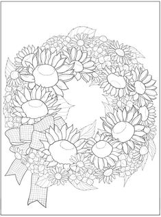 a wreath with sunflowers and apples on it is shown in black and white