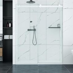 a modern bathroom with marble tile and white fixtures, including a shower head in the center