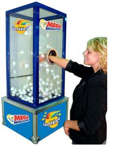 a woman standing next to a machine filled with balls