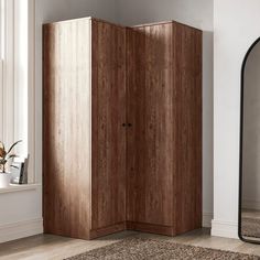 a room with a large mirror and wooden cabinet in it, next to a rug on the floor