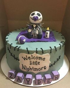 a birthday cake decorated with a skeleton sitting on it's lap and writing welcome little nightmares