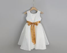 Make your little one feel like a princess with our elegant Ivory Satin Flower Girl Dress, available with a choice of gold, rose gold, or ivory sash. This stunning dress features a soft ivory satin bodice paired with a flowy tulle skirt, perfect for weddings or any special occasion. The variety of sash colors adds a touch of customization and sophistication, making it an ideal choice for both big sister and little sister to shine at the event. Whether for a wedding party or a formal celebration, Gold Sash, Satin Flower Girl Dress, Big Sister Little Sister, Girls Tulle Dress, Sisters Dress, Smash Cake Photoshoot, Satin Flowers, Stunning Outfits, Dress Satin