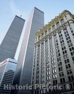 two tall buildings are in the middle of a city with skyscrapers on either side