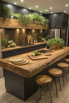 a large kitchen with an island and lots of plants on the counter top in front of it