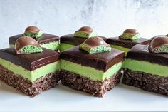 four pieces of cake with chocolate and green frosting