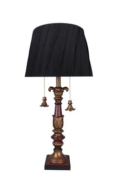 a lamp that is sitting on top of a wooden stand with a black shade over it