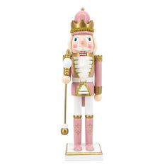 a pink and gold nutcracker ornament on a white background with a golden crown