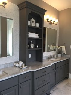 a bathroom with double sinks and large mirrors