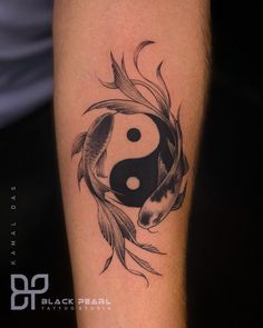 a black and white tattoo with a fish and a yin - yang symbol