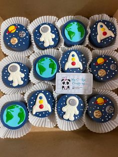 cupcakes in the shape of outer space are on display