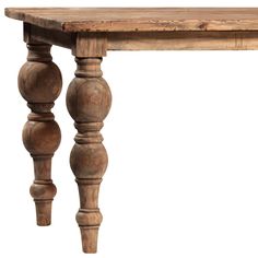 an old wooden table with two turned legs