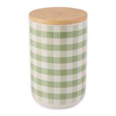 a green and white checkered canister with wooden lid