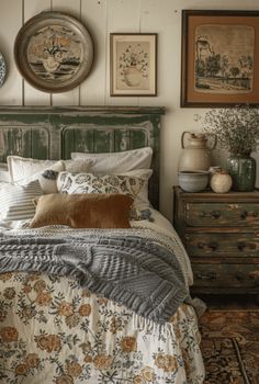 a bed sitting in a bedroom next to two dressers and pictures on the wall