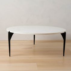 a white table sitting on top of a hard wood floor