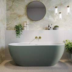 a bathroom with a round mirror above the bathtub and potted plants on the wall