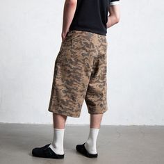 The Deconstructed Camo Cargo Shorts seamlessly blend vintage style with meticulous craftsmanship. These cargo shorts feature a faded, washed camo design that adds a rugged, retro vibe. The shorts are equipped with multiple pockets: two on each side of the front with rivet embellishments and two on each side of the back for ample storage. A logo patch at the back waistband and a zip closure enhance its functional design. Made from premium 100% cotton fabric, these shorts offer a slightly oversize Camo Cargo Shorts, Camo Designs, Brand Sale, Retro Vibe, Accessories Branding, Functional Design, Sale Design, Cargo Shorts, Patch Logo