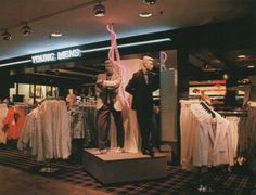 a store with mannequins and shirts on display