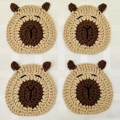 three crocheted animal coasters with faces on them