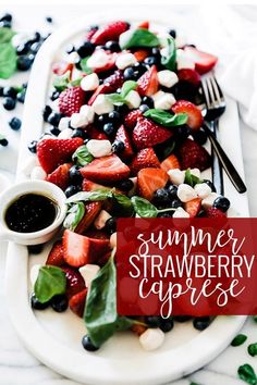 a white plate topped with strawberries and blueberries