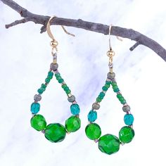 These colorful beaded teardrop hoop style earrings feature green Czech glass beads coordinated with green matte and shiny metallic gold Japanese Toho seed beads. Rose-gold plated copper ear wires complete these light weight and easy to wear earrings. Details Handmade item Ships from Texas Length: 2 Inches; Width: .75 Inches Materials: Gold plated copper, Crystal glass Closure: Ear wire Hoop Beaded Earrings, Abalone Earrings, Copper Crystal, Tanzanite Earrings, Gold Fringe, Fringe Earrings, Style Earrings, Czech Glass Beads, Ear Wire