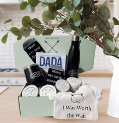 a father's day gift box with personalized items and a vase filled with greenery