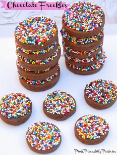 chocolate cookies with colorful sprinkles are stacked on top of eachother