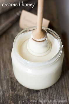 a jar of cream with a wooden spoon in it