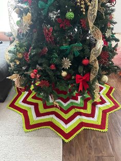 a crocheted christmas tree skirt is on the floor