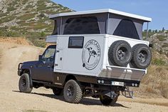 an off road vehicle parked on a dirt road