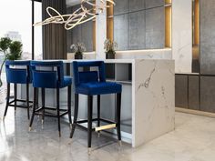 an elegant bar with marble counter tops and stools next to it in a room