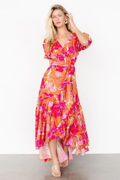 Make a statement in the colorful Lori Maxi Dress, featuring a vivid orange and pink floral print. This dress includes fun features like a high-low tulip skirt, ruffle detail, and short puff sleeves. Vibrant V-neck Maxi Dress For Spring, Vibrant Printed Maxi Dress For Spring, Vibrant V-neck Maxi Dress With Floral Print, Spring Tropical Print Maxi Dress With Short Sleeves, Spring Maxi Dress With Tropical Print And Short Sleeves, Pink V-neck Maxi Dress With Tropical Print, Pink Tropical Print V-neck Maxi Dress, Vibrant Flowy Floral Print Maxi Dress, Vibrant Floral Print Maxi Dress For Day Out