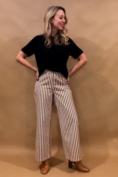 Introducing our Striped Wide Leg Pants, the perfect balance of style and comfort! The vertical stripes create a flattering elongated look, while the elastic back waist and belt loops provide a customizable fit. Button and zip closure with five pockets, these pants offer both functionality and fashion. Lightweight fabric so no bulk with these pants. Fit: true to size, Amber is 5'6", modeling size small. Content: cotton blend. Imported. Striped Pants Outfit Women, Pinstripe Trousers Outfit, Pinstripe Pants Outfit, Striped Pants Outfit, Stripe Pants Outfit, Office Girl, Trouser Outfit, Striped Wide Leg Pants, Better Style