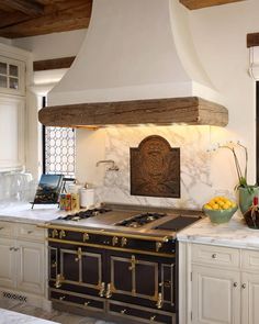 a kitchen with an oven, stove and counter tops in it's center island