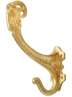 a gold colored metal hook with a lion head on it's end and an ornate design