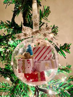 a christmas ornament hanging from a tree filled with presents