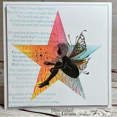 a card with a fairy sitting on top of a star