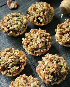 small cupcakes with nuts and other toppings on a table