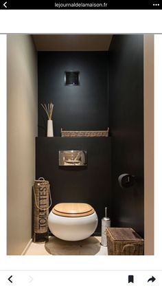 the bathroom is decorated in black and white with an unusual toilet seat that's built into the wall