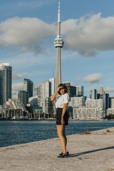 a woman standing in front of the toronto skyline