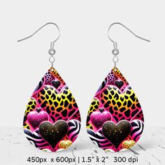 a pair of earrings with hearts and leopard print