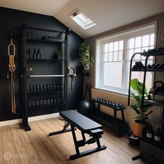 a home gym with black walls and wooden floors