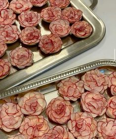 several trays filled with pink flowers on top of a table