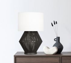 a table lamp sitting on top of a wooden dresser